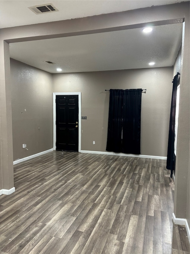 empty room with dark hardwood / wood-style floors