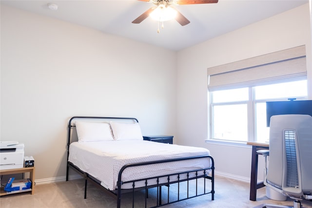 bedroom featuring light carpet and ceiling fan