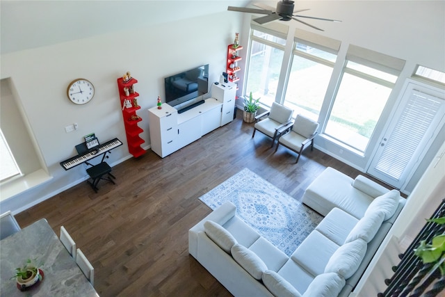 living room featuring ceiling fan, dark hardwood / wood-style flooring, and lofted ceiling