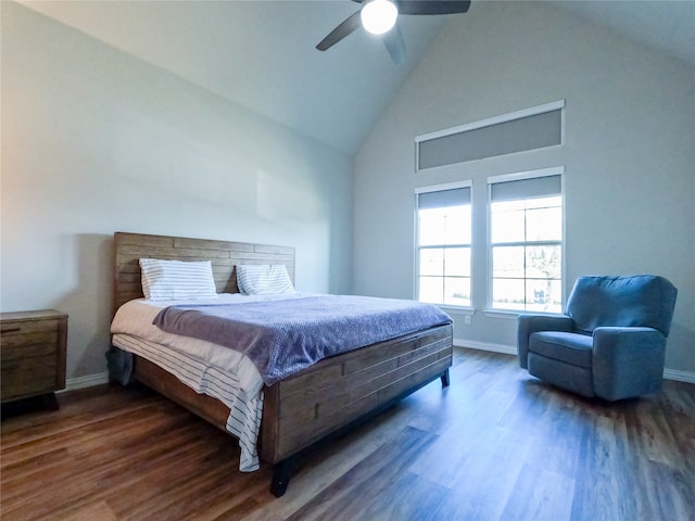 bedroom featuring dark hardwood / wood-style floors, ceiling fan, and high vaulted ceiling