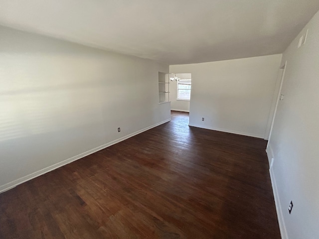 empty room with dark wood-type flooring