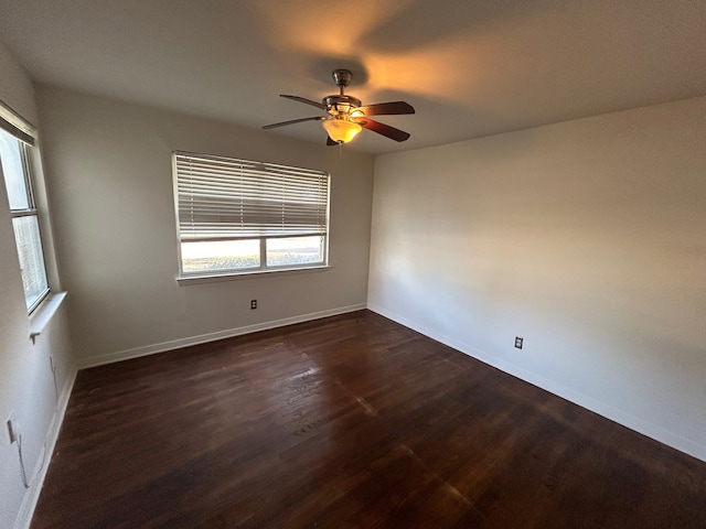 unfurnished room with dark hardwood / wood-style floors and ceiling fan