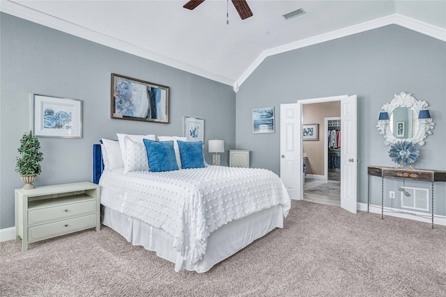 carpeted bedroom with vaulted ceiling, ceiling fan, and crown molding