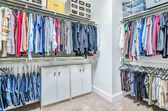 walk in closet featuring carpet flooring