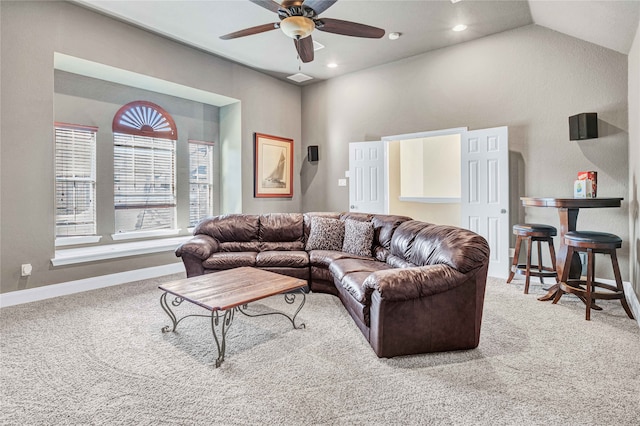 living room with carpet flooring, ceiling fan, and vaulted ceiling