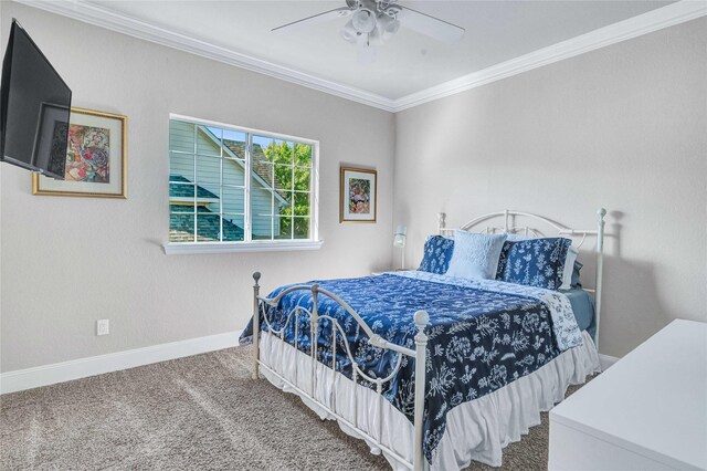 carpeted bedroom featuring ceiling fan and ornamental molding