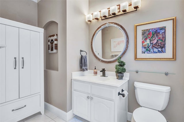 bathroom with tile patterned flooring, vanity, and toilet