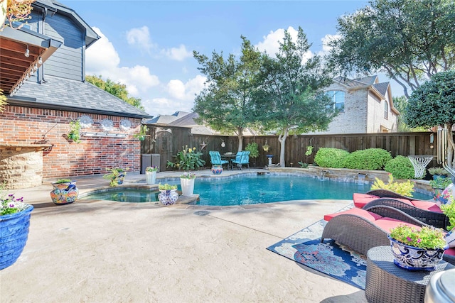 view of pool with an in ground hot tub and a patio