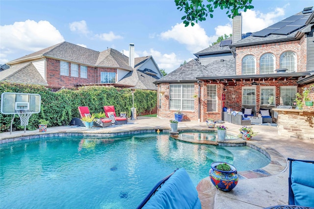 view of pool with an in ground hot tub and a patio area