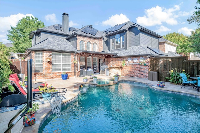 view of pool featuring an in ground hot tub and a patio