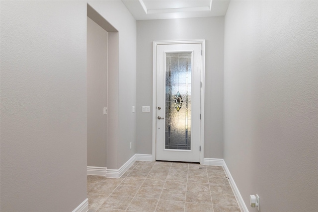 doorway to outside with light tile patterned flooring