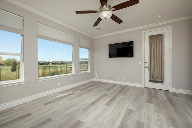 interior space featuring light hardwood / wood-style flooring, ceiling fan, a healthy amount of sunlight, and crown molding