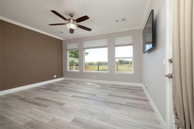 empty room featuring crown molding, light hardwood / wood-style flooring, and ceiling fan