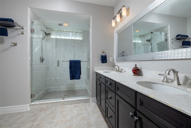 bathroom with tile patterned floors, a shower with door, and vanity