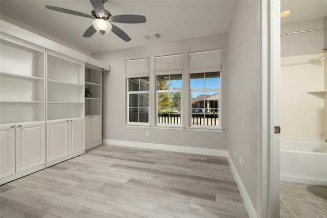 spare room with ceiling fan and light hardwood / wood-style flooring