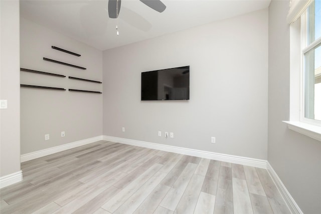 spare room with ceiling fan and light wood-type flooring