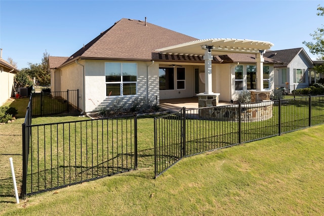 back of property with a yard, a pergola, and ceiling fan