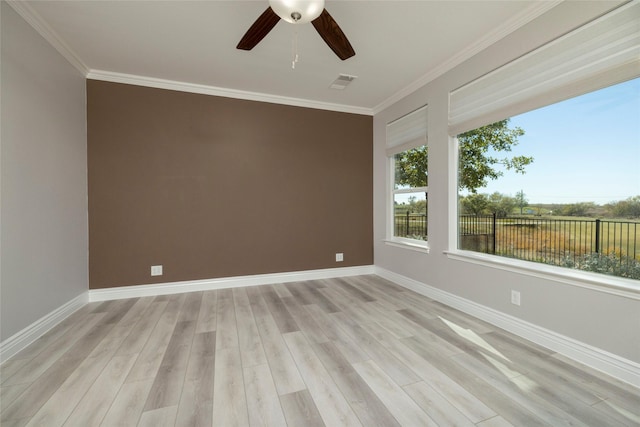 empty room featuring ceiling fan, ornamental molding, and light hardwood / wood-style flooring