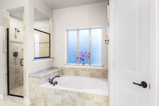 bathroom with shower with separate bathtub and plenty of natural light