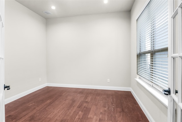 spare room with dark hardwood / wood-style floors