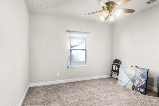 carpeted empty room featuring ceiling fan