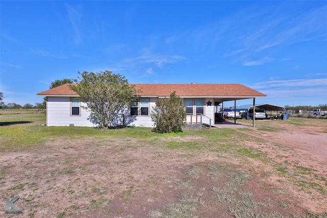 rear view of property featuring a yard and a carport