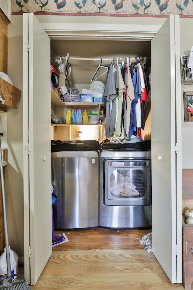 washroom with separate washer and dryer and light hardwood / wood-style flooring