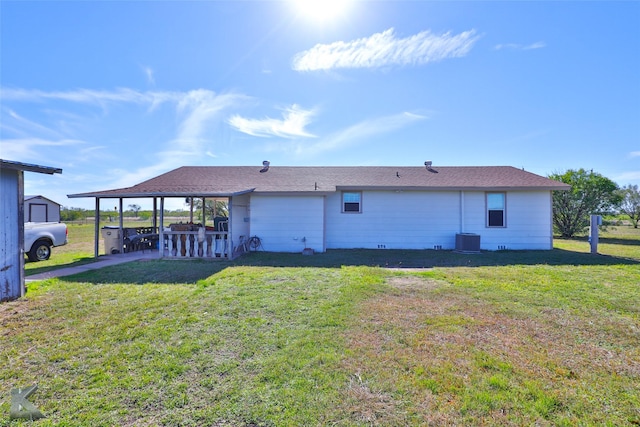 back of house with cooling unit, a patio, and a lawn