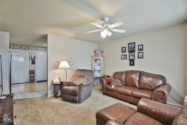 carpeted living room with ceiling fan