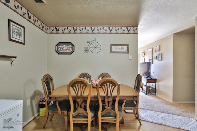 dining room with a textured ceiling