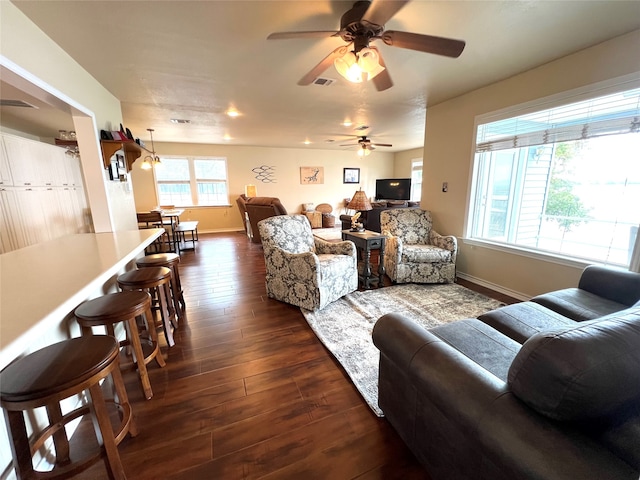 living room with dark hardwood / wood-style floors and ceiling fan