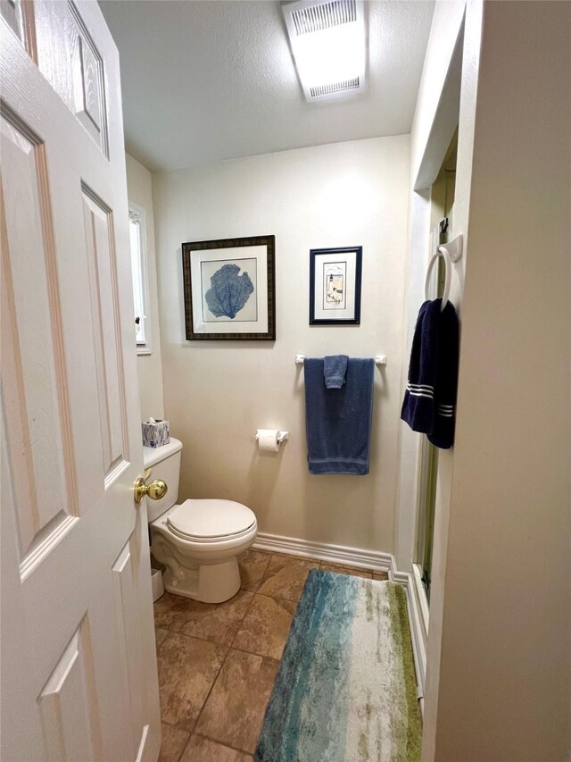 bathroom with tile patterned floors and toilet