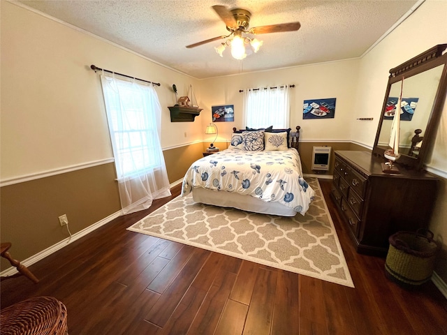 bedroom with a textured ceiling, heating unit, ceiling fan, and dark wood-type flooring