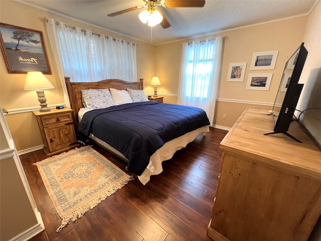 bedroom featuring a textured ceiling, dark hardwood / wood-style floors, ceiling fan, and crown molding