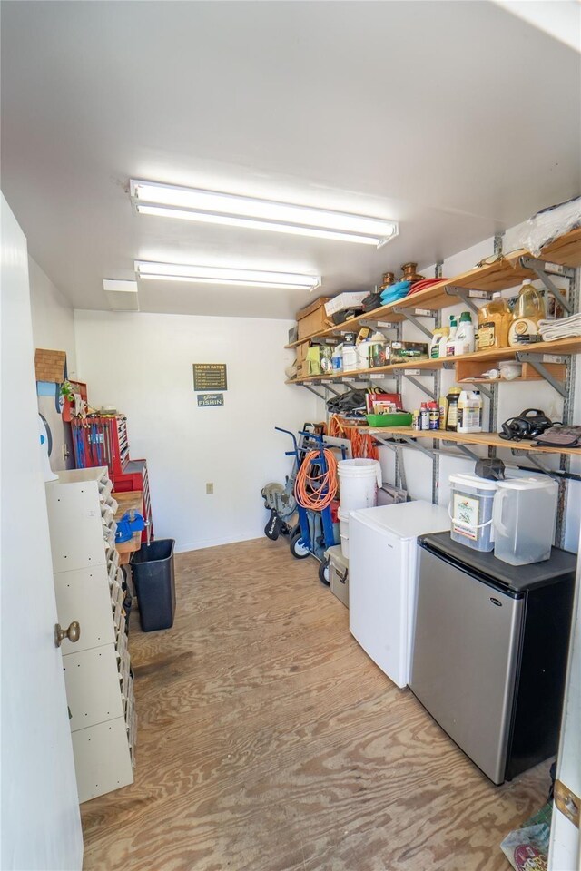 laundry area with light wood-type flooring