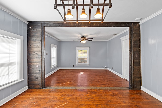 spare room with hardwood / wood-style floors, crown molding, and ceiling fan