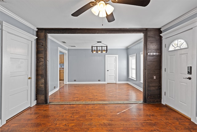 foyer entrance with a wealth of natural light, dark hardwood / wood-style flooring, and ceiling fan with notable chandelier