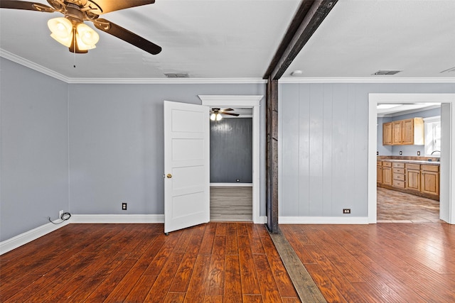 unfurnished room with crown molding, dark hardwood / wood-style floors, and ceiling fan