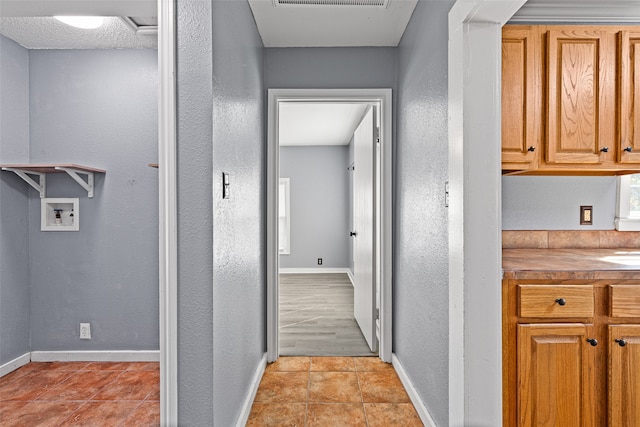 hall with light tile patterned flooring