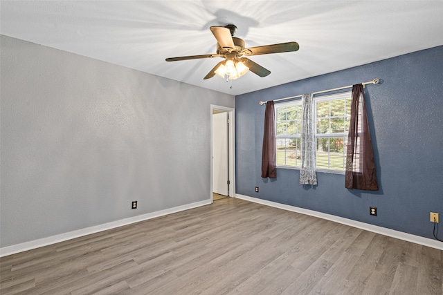 unfurnished room with ceiling fan and light hardwood / wood-style flooring