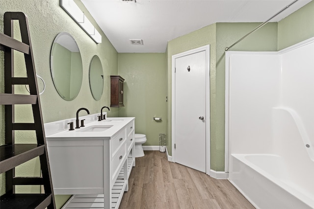 full bathroom featuring vanity, toilet, independent shower and bath, and hardwood / wood-style floors