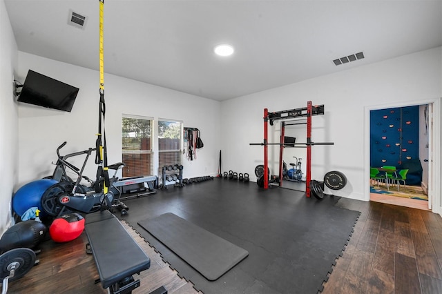 exercise area with dark hardwood / wood-style flooring