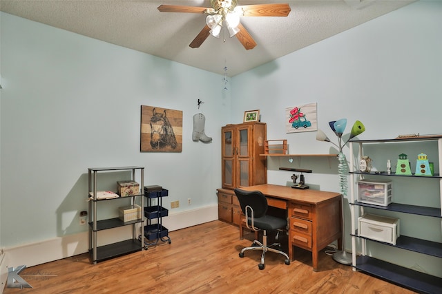 home office featuring wood-type flooring, a textured ceiling, and ceiling fan