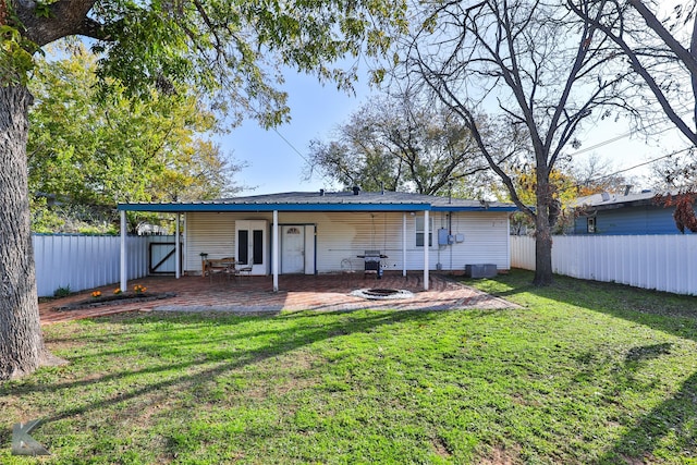 rear view of house featuring a patio area and a lawn