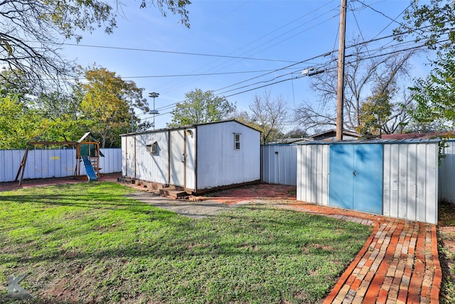 view of outdoor structure with a yard and a playground