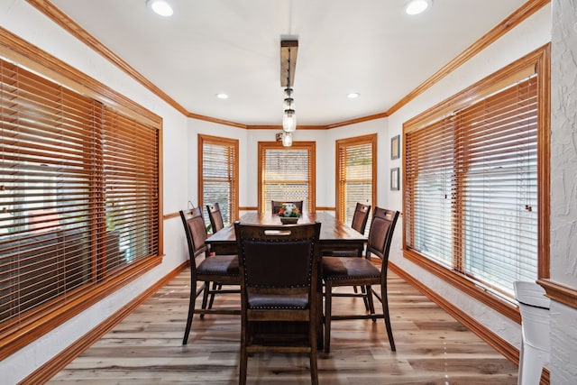 dining room featuring hardwood / wood-style flooring and crown molding