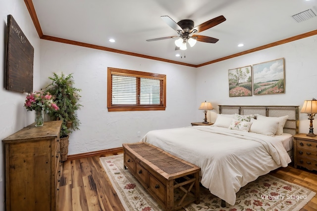 bedroom featuring ceiling fan, wood-type flooring, and ornamental molding