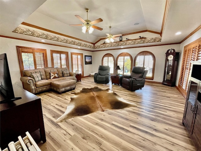 living room with light hardwood / wood-style floors, crown molding, and a wealth of natural light