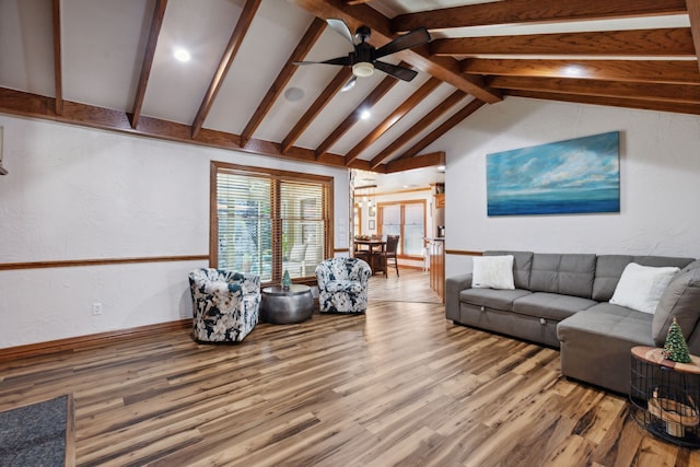 living room with hardwood / wood-style floors, vaulted ceiling with beams, and ceiling fan