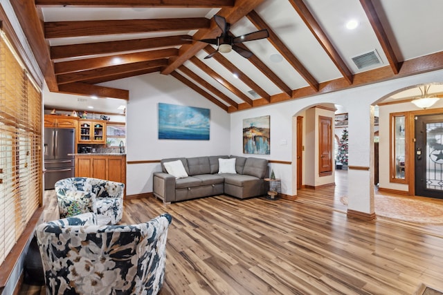 living room with beam ceiling, light hardwood / wood-style floors, high vaulted ceiling, and ceiling fan